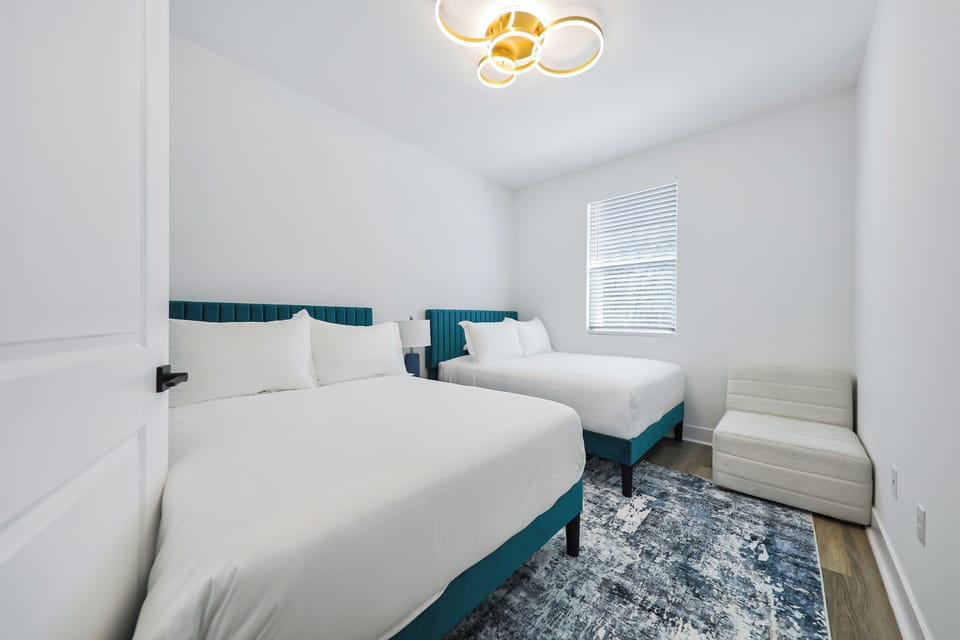 Located upstairs-Bedroom retreat with two double beds and warm, inviting decor.