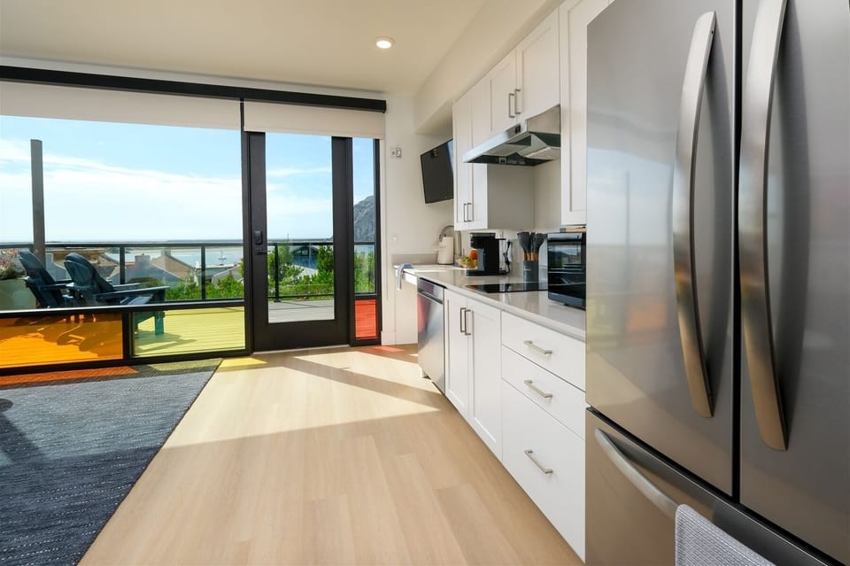 Kitchen includes full-size fridge, microwave, electric double burner, Keurig, and dishwasher