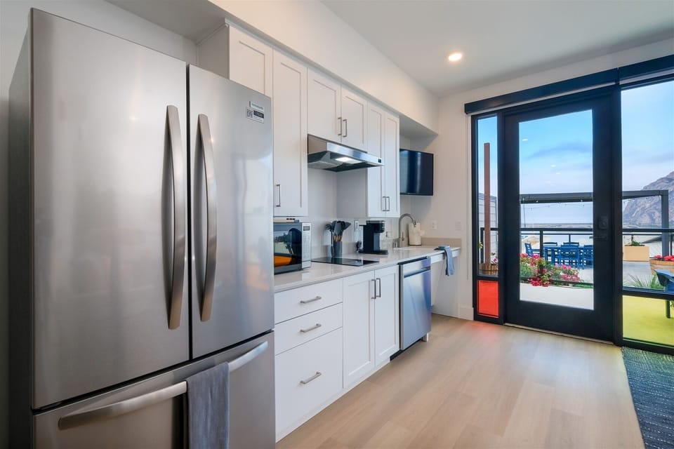 Kitchen includes full-size fridge, microwave, electric double burner, Keurig, and dishwasher