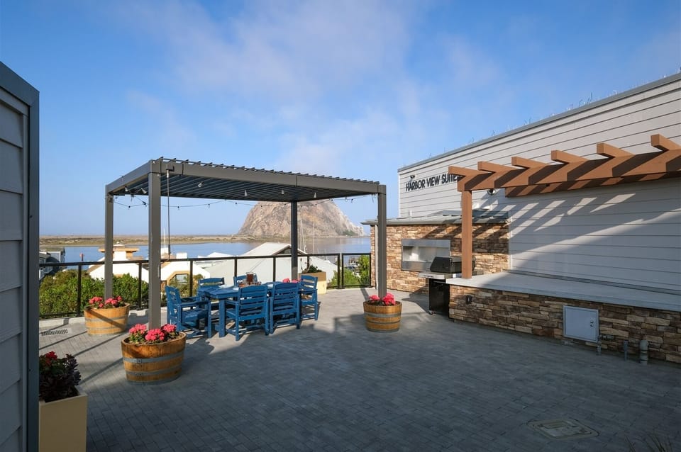 Outdoor community BBQ area with fireplace and bay views