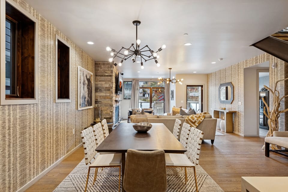Contemporary dining room with long wooden table and modern design details