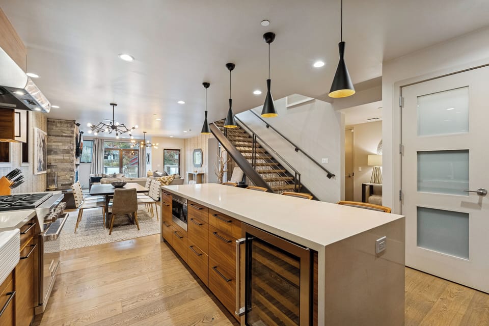 Spacious kitchen with breakfast bar, pendant lighting, and open layout