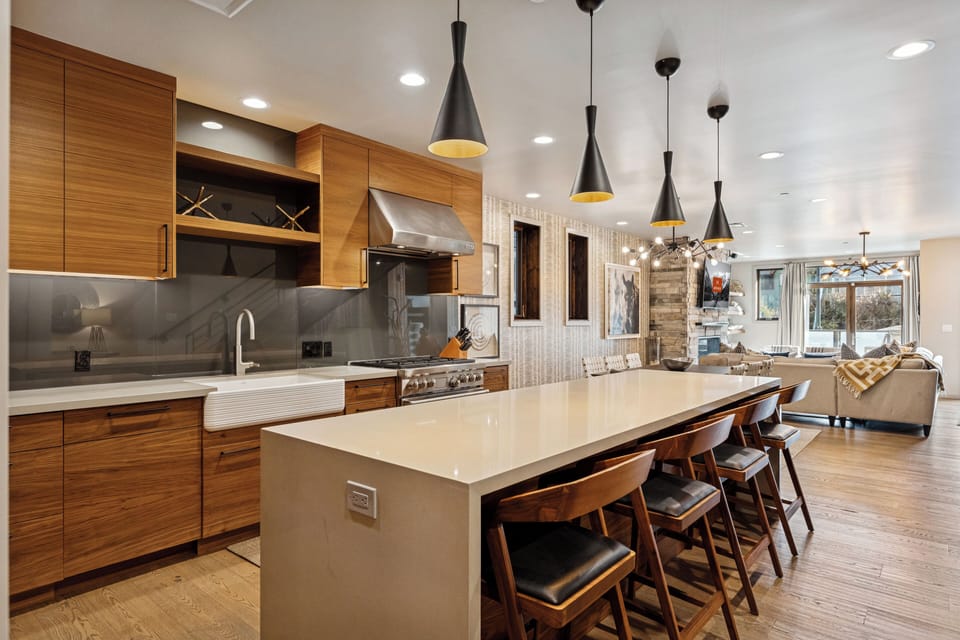 Expansive kitchen with bar seating, natural wood finishes, and open floor plan