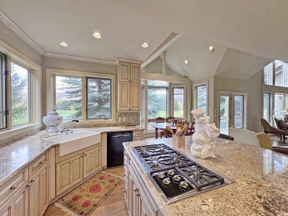 This elegant kitchen with a Wolf stovetop is plenty big to serve the 14 guests that this home is equipped to host