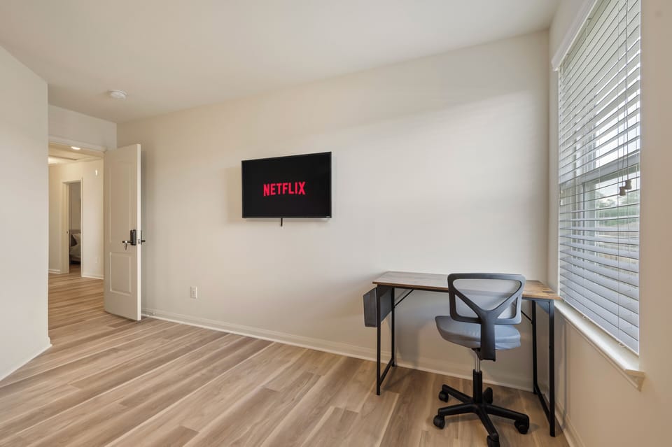 Spacious king bedroom with Smart TV, dedicated workspace and walk-in closet