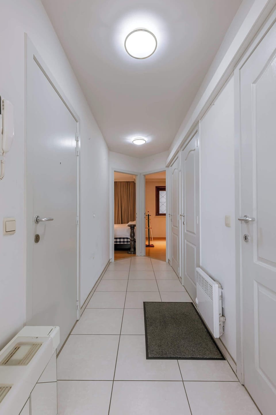 Neat hallway connecting all rooms, airy and well-lit