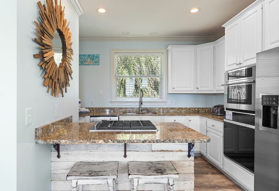 Modern kitchen with granite countertops and stainless steel appliances.