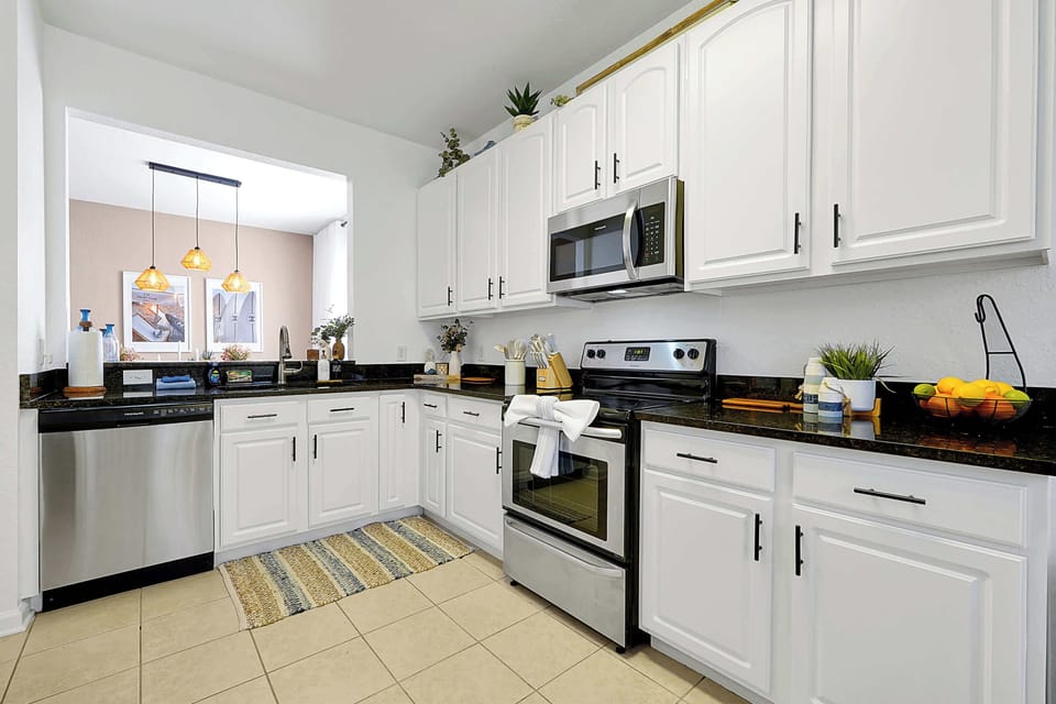Modern kitchen with stainless steel appliances and white cabinetry