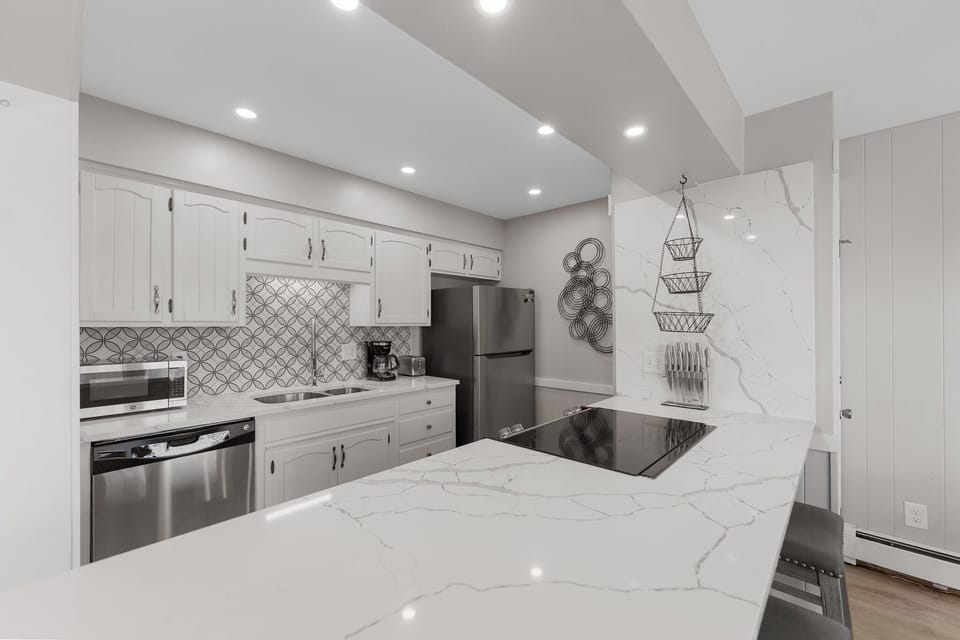 Your gourmet kitchen features marble countertops, stainless steel appliances, and stylish backsplash—perfect for preparing memorable meals during your stay.