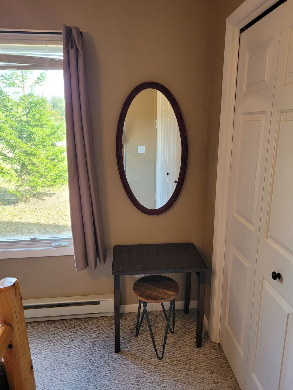 BEDROOM #1 (FIRST FLOOR):  Features a beautiful queen-size bed, ceiling fan, dresser, nightstand, lamp, closet, and makeup table with chair and mirror.