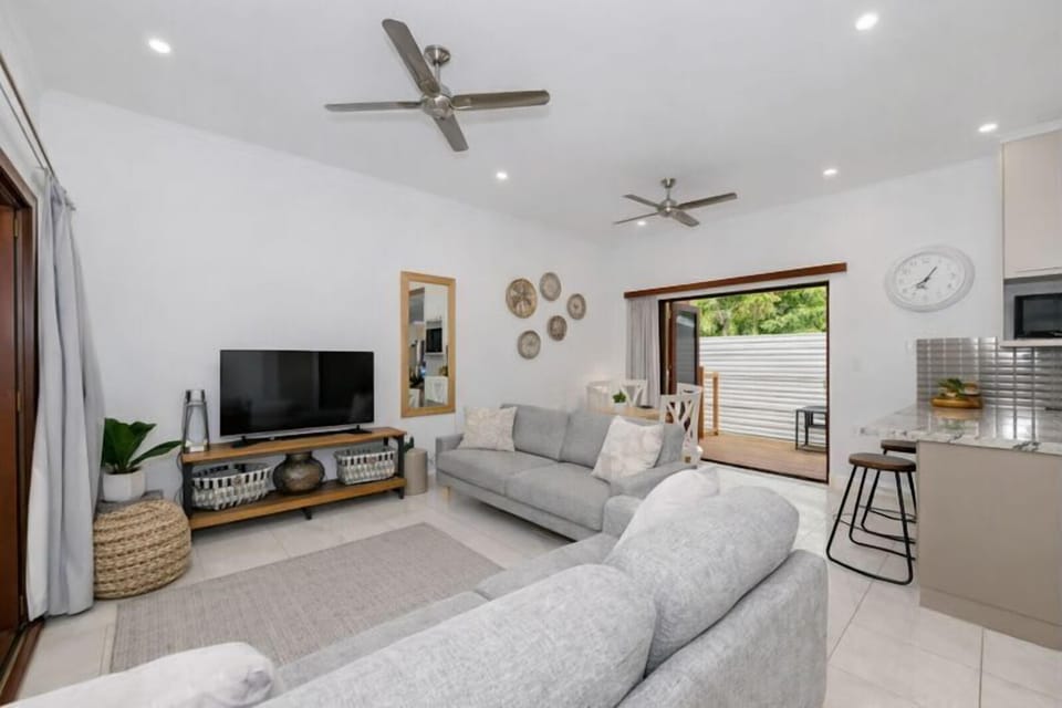 Spacious lounge with ceiling fan and relaxed seating area.