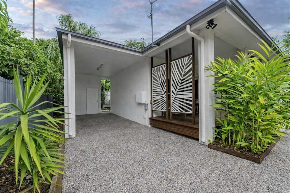 Private tropical courtyard with lush greenery.