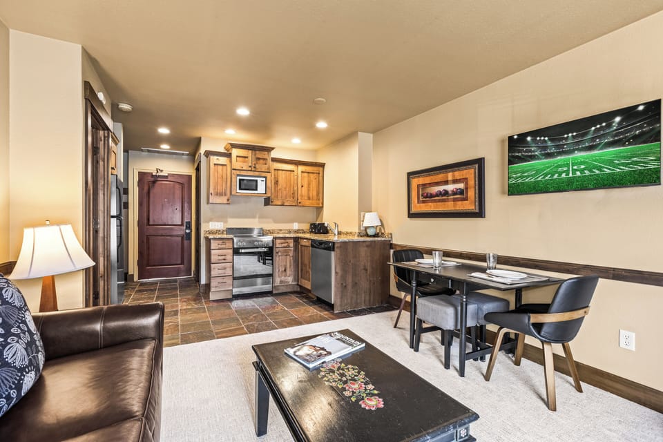 The open concept living area with efficient kitchen and dining table for two guests.