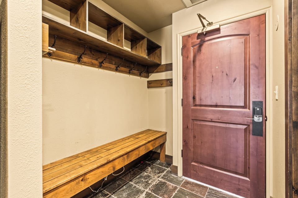 The entryway with a large bench and plenty of space to put outdoor gear.