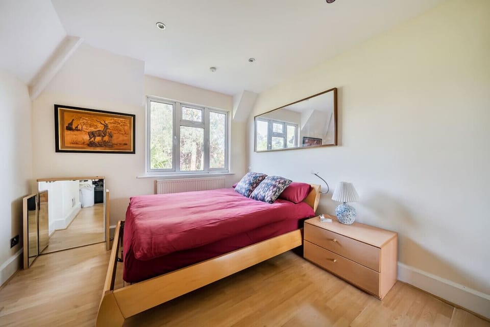 Top-floor bedroom with sloped ceiling and dresser