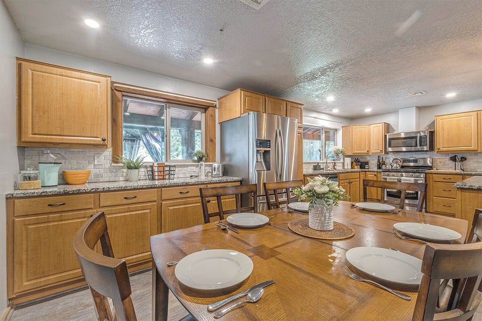 Cook, dine, connect— stocked kitchen, island, coffee and popcorn, dining area