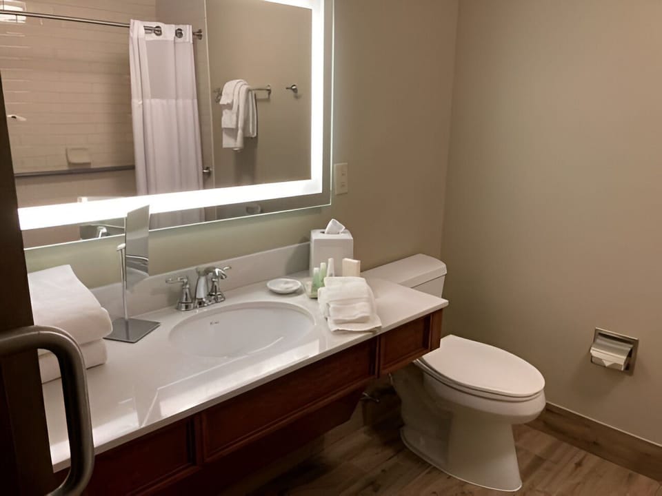 Well-lit vanity and elegant finishes offer a smooth start to your day or a peaceful wind-down at night.