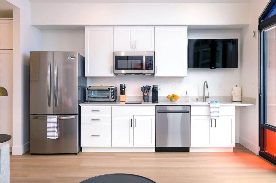 Kitchen includes full-size fridge, microwave, electric double burner, toaster oven, Keurig, and dishwasher