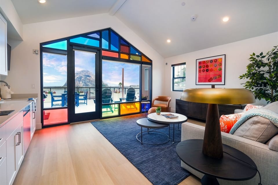 Enjoy light pouring through avant-garde windows in living room and kitchen spaces