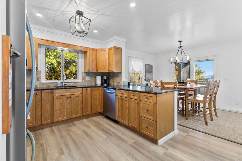 A full kitchen area with an adjacent dining area.
