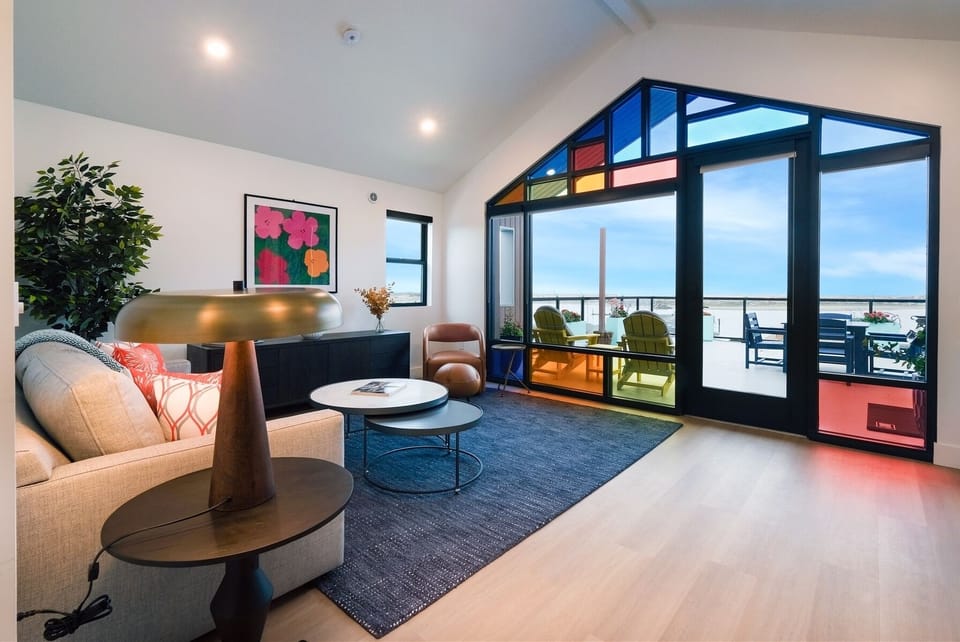 Enjoy light pouring through avant-garde windows in living room and kitchen spaces
