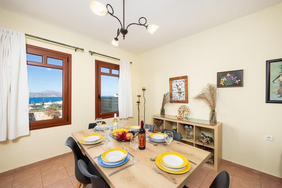 Living room with sofa, dining area, ornamental fireplace, A/C, WiFi internet, and satellite TV