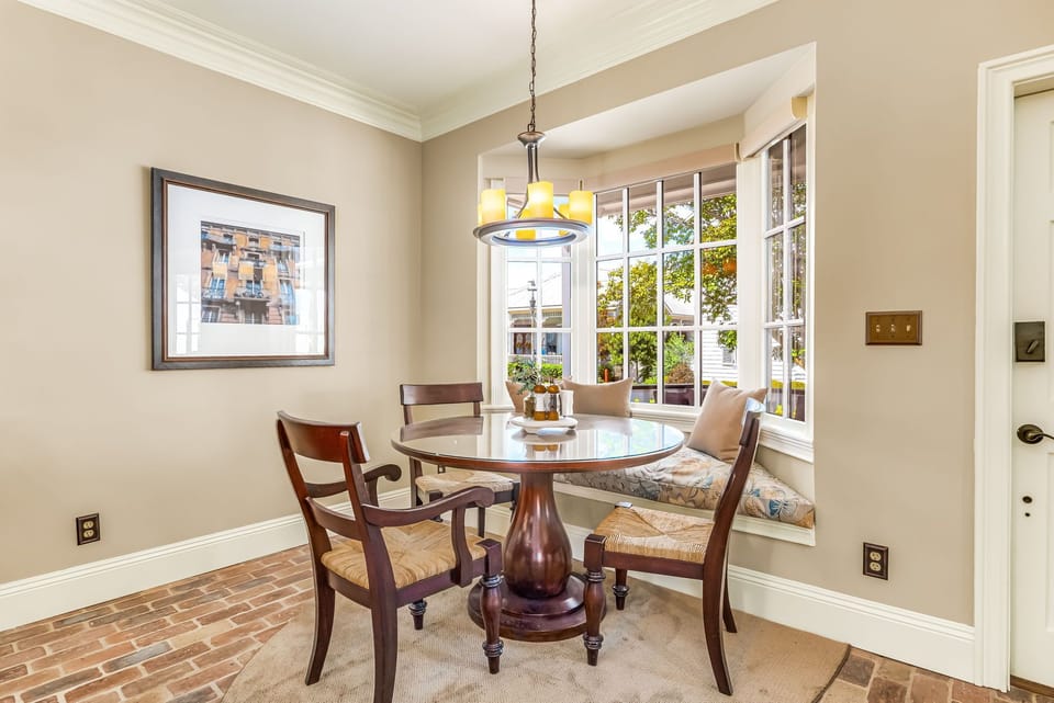 Window seat dining nook with natural light in downtown Pensacola cottage near Seville Square