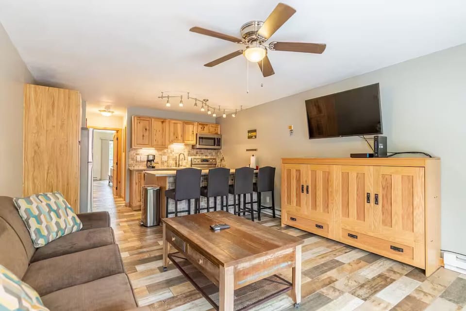 Cozy living area with ceiling fan, Smart TV, and extra sleeping arrangements.