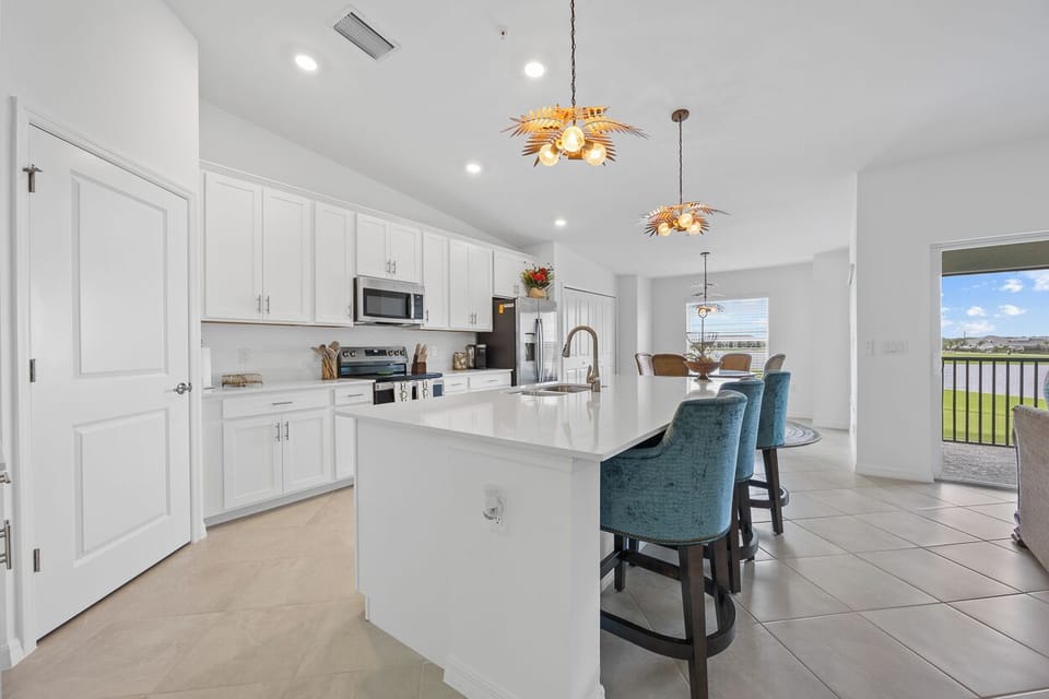 Eat in kitchen with comfortable swivel barstools with backs.