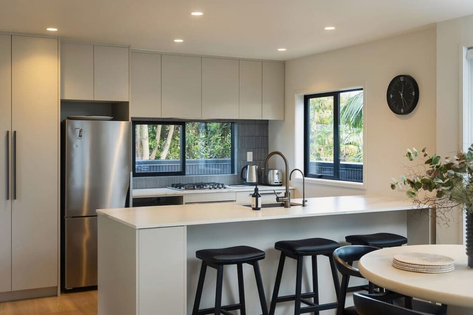 Modern spacious open plan living and dining, leading out to the sunny covered deck with additional dining and BBQ