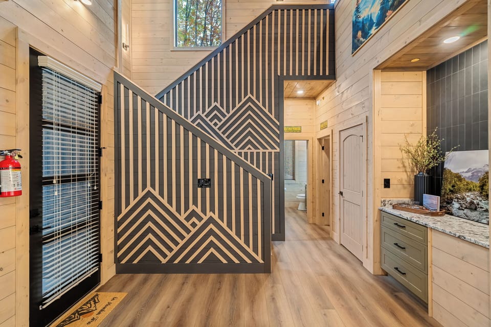 Stylish entryway featuring custom mountain-themed woodwork