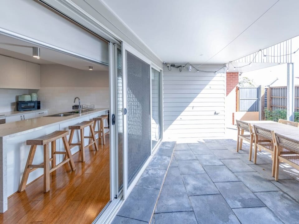 Covered outdoor area with seating, perfect for entertaining or relaxing.