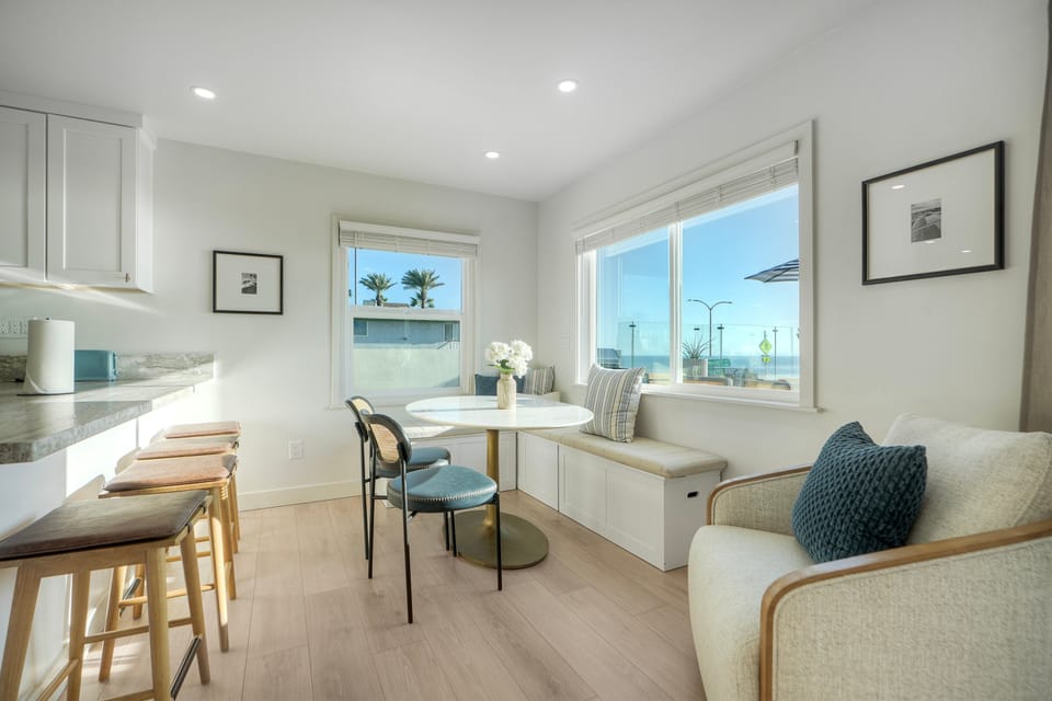 Cozy dining corner with ocean-view windows.
