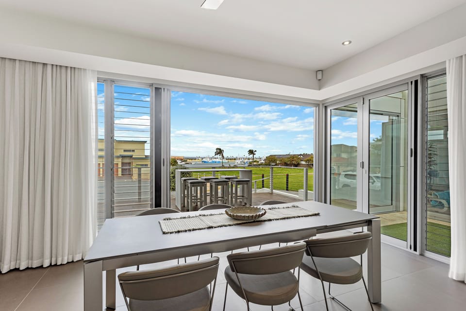 Light filled dining space seamlessly flows to the elevated front deck.
