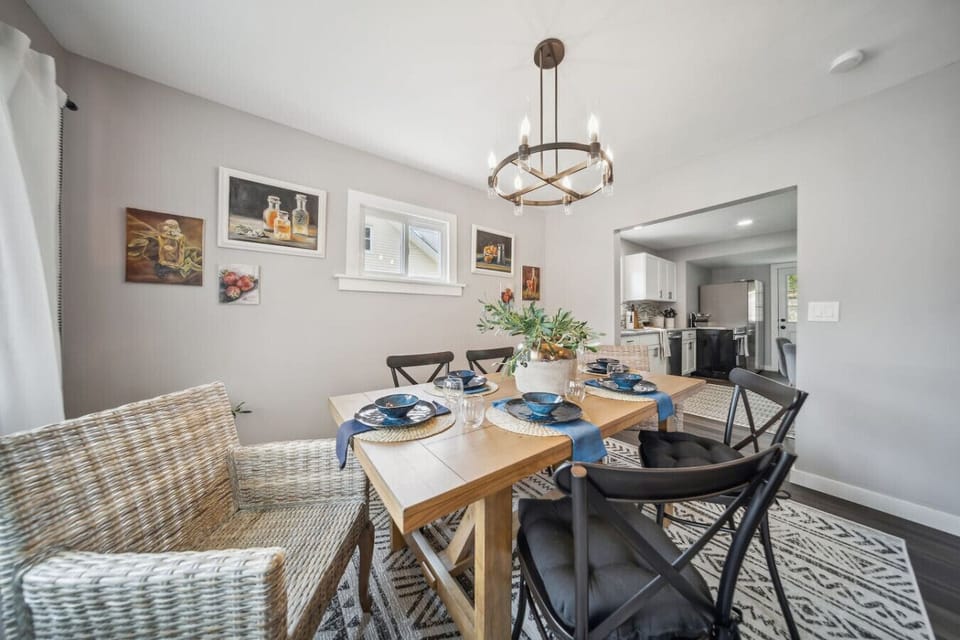 Conveniently located just off the kitchen, the dining space features a beautiful wooden table and an open layout, making it easy to serve meals and stay connected with everyone in the home.