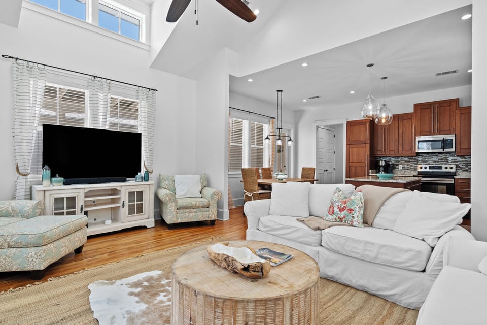 Bright open-concept living area with cozy seating and a TV.