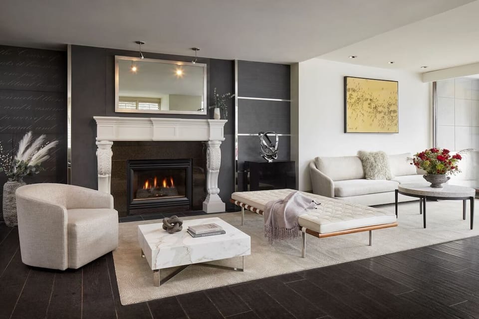 Unwind by the glowing fireplace in a calm, elegant lounge.