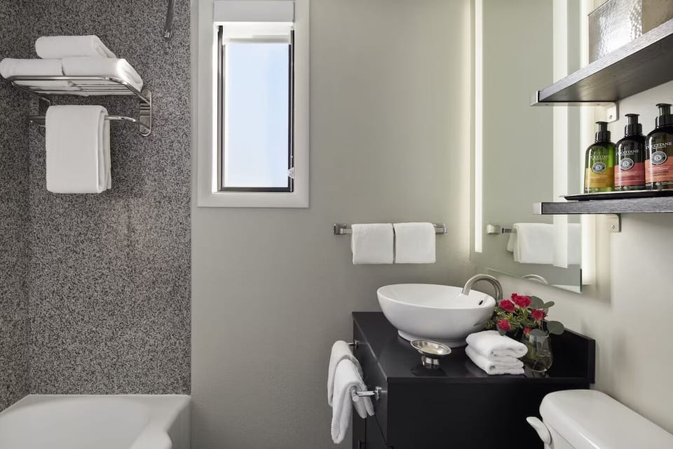 Refresh in a spotless bath with fluffy towels and amenities.