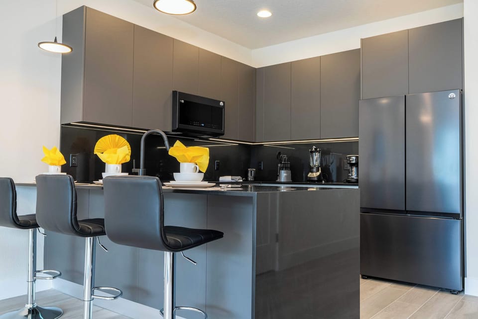 Pull up a stool at the stylish kitchen island. This modern culinary space features high-end appliances and plenty of room for quick morning breakfasts or evening snacks.