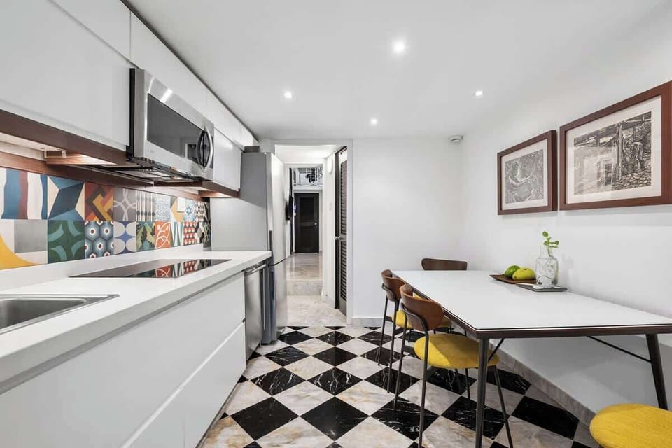 Minimalist cooking: Clean, white lower cabinets and simple design.	