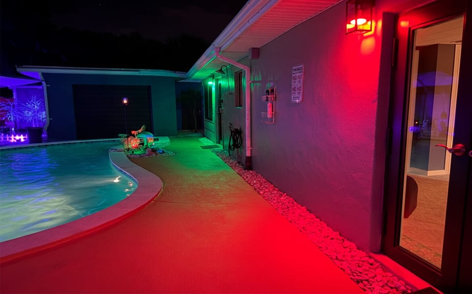 Evening poolside setting at Garden of Manors near The Red Room, enhanced by ambient lighting and tropical surroundings.