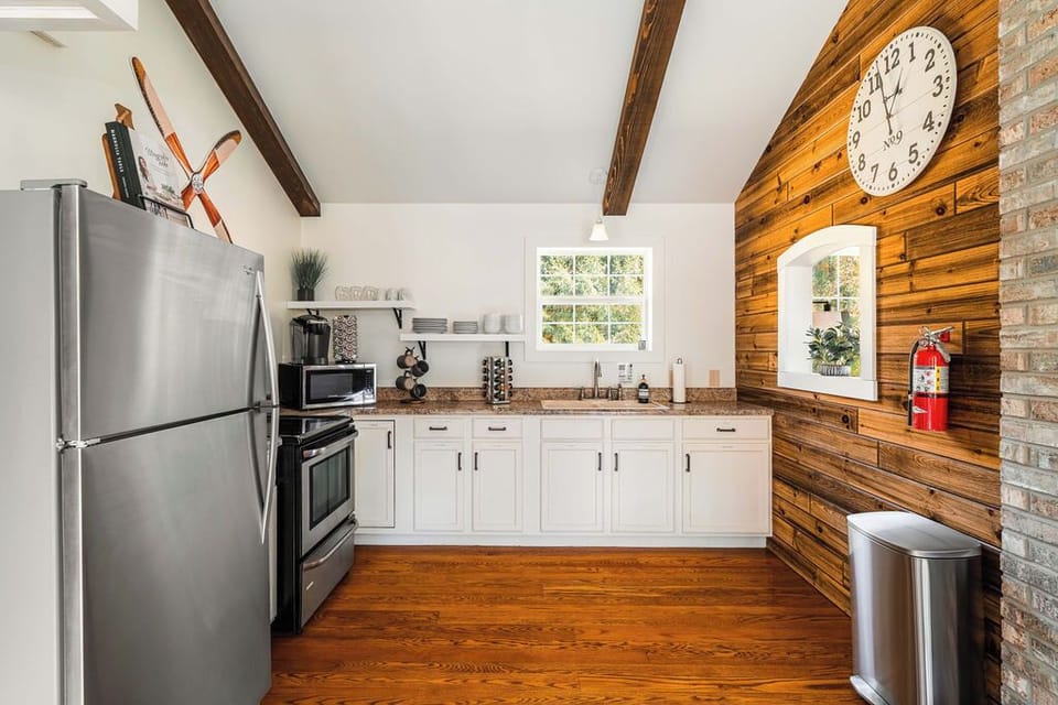 Our stylish kitchen blends rustic charm with modern convenience—stainless steel appliances, open shelving, and everything you need to cook and connect.