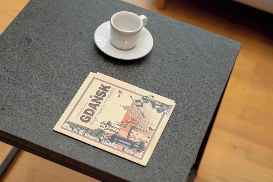 A cup of coffee on the table invite you to slow down and enjoy a calm morning.