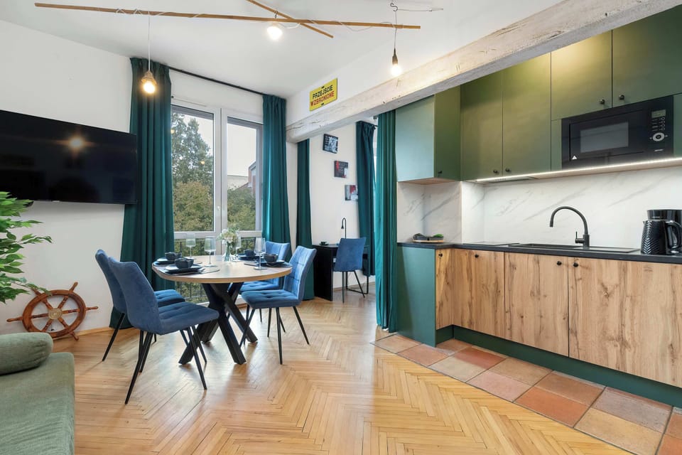 Modern and bright space with a comfortable sofa, dining table, and a fully equipped kitchen.