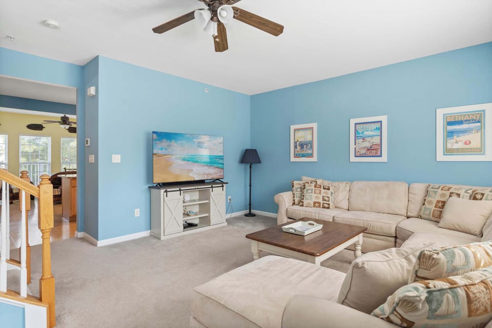 Curl up in the coastal chic living room & stream your favorites on the smart TV​