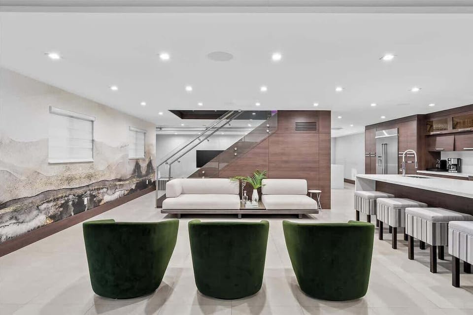 Spacious open-concept living area with smart TVs and designer furnishings.