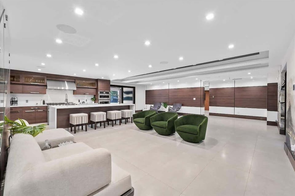 Spacious open-concept living area with smart TVs and designer furnishings.