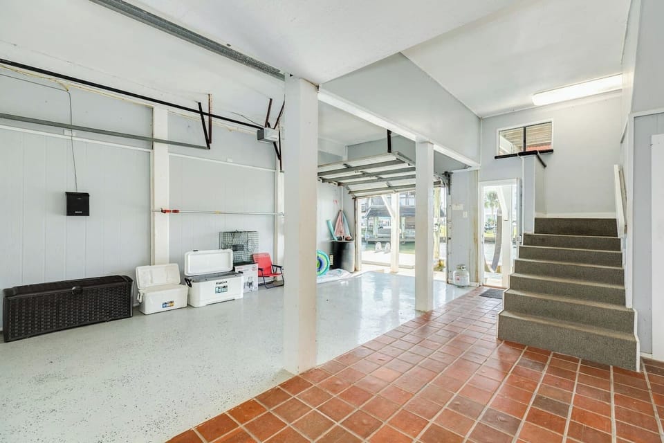 Easy, covered entry! The interior staircase leads directly from the ground level to the main living floor, providing sheltered access for luggage and gear.