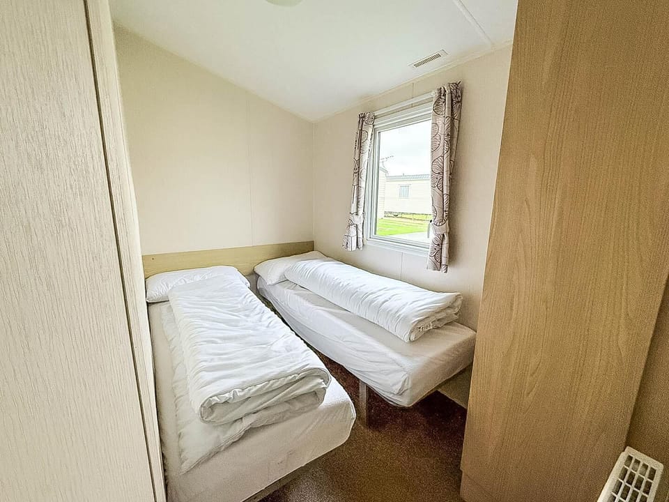 Cozy twin bedroom with natural light and peaceful views