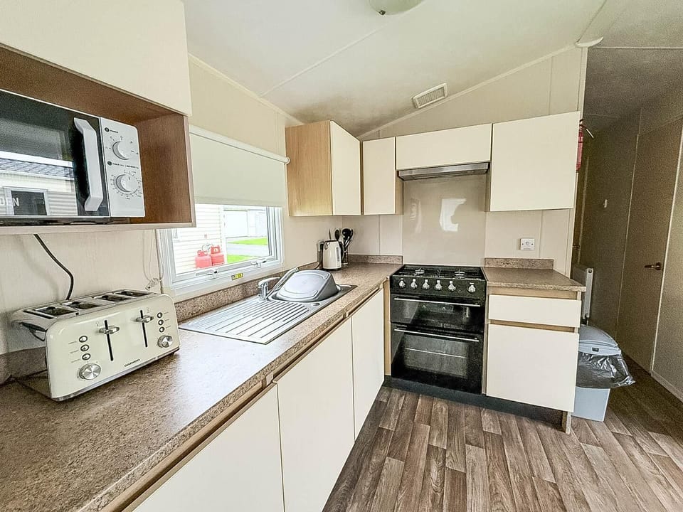 Bright, fully equipped kitchen with modern appliances and cozy charm